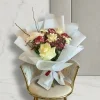 Cream White Rose Bouquet 1 Elegant cream white rose bouquet with red carnations wrapped in crisp white paper