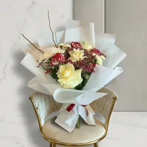Cream White Rose Bouquet 1 Elegant cream white rose bouquet with red carnations wrapped in crisp white paper