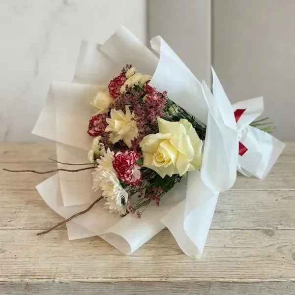 Cream White Rose Bouquet 3 Elegant cream white rose bouquet with red carnations wrapped in crisp white paper