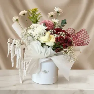 Luxury Mixed Flower Box – Elegant White Hat Box Bouquet 1 Luxury mixed flower box with white roses, burgundy mums, pink disbud chrysanthemums, and hanging amaranthus in a white hat box